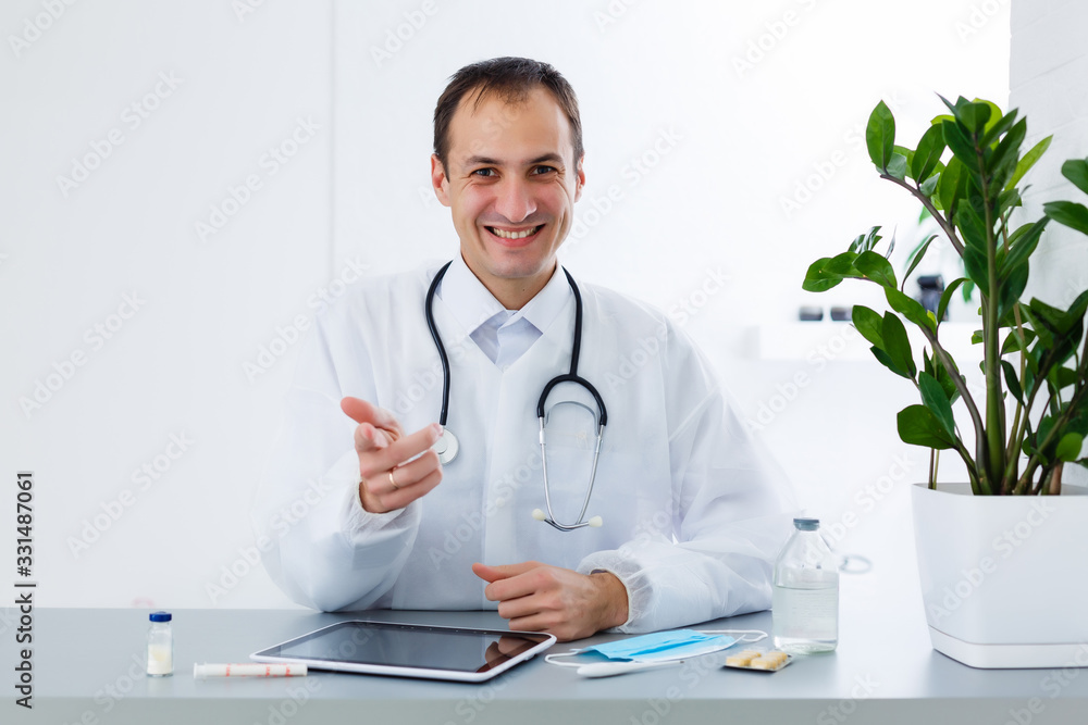 Young male doctor with tablet in office Young male doctor with tablet in office