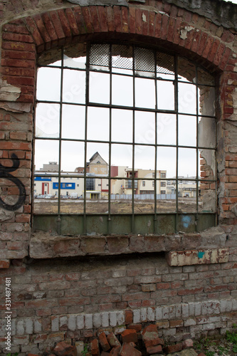 A view from a window of a demolished building  old factory. Weathered wall. Broken window.