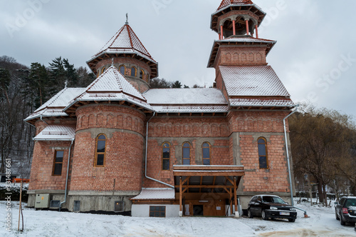 Fototapeta Naklejka Na Ścianę i Meble -  Church made of bricks. Rooftop covered with snow. Winter scene.