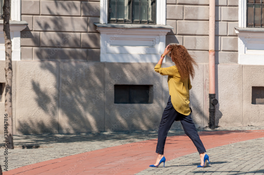 Woman walking on the street. Real people.