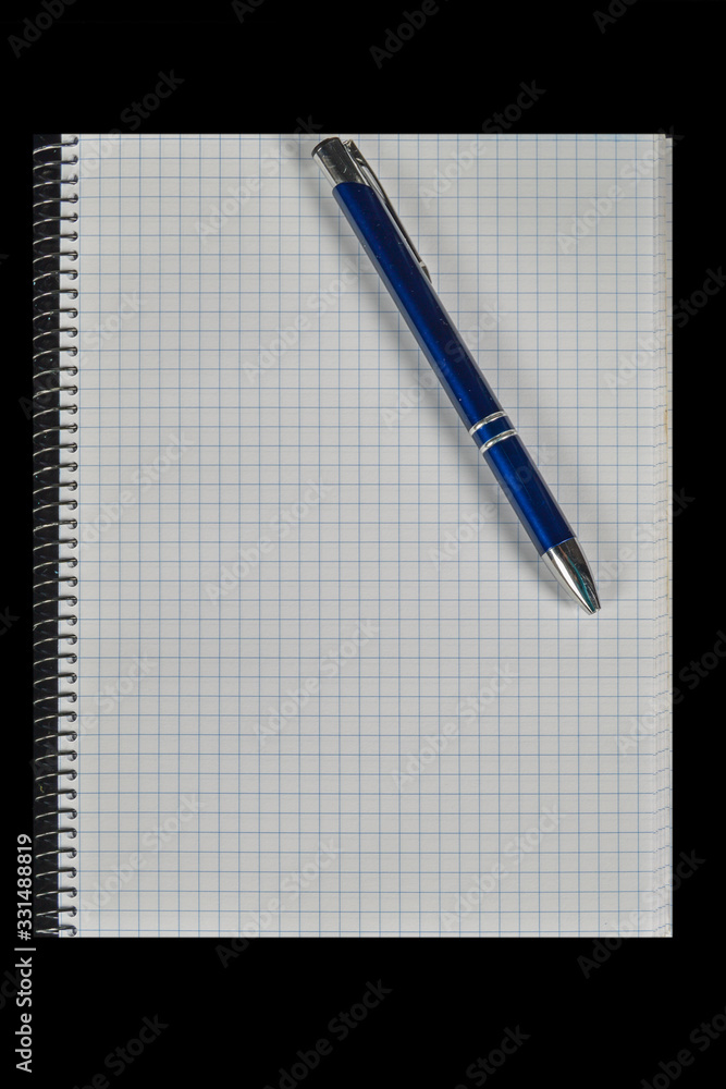 squared notebook with pen on black background squared notebook with pen on black background