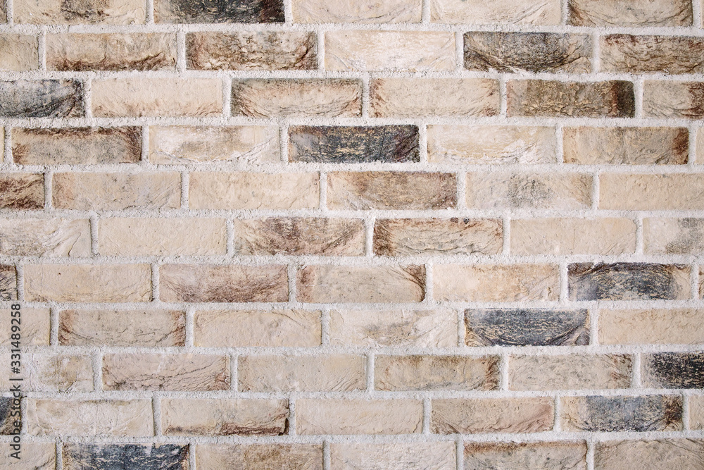 Obraz premium Brick wall of old faded beige bricks as a background. Grunge loft texture.