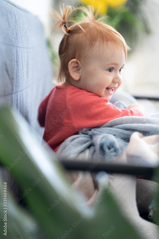 Cute red hair baby girl with big brown eyes in pink dress having fun laughing and playing. Beautiful kid with perfect white skin. Close up portrait. Сhildren's room. Cute red hair baby girl with big brown eyes in pink dress having fun laughing and playing. Beautiful kid with perfect white skin. Close up portrait. Сhildren's room.