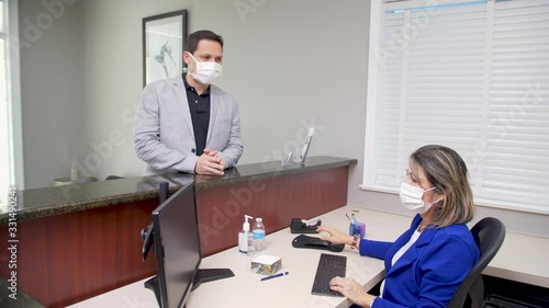 387 Man entering reception with surgical mask coronavirus