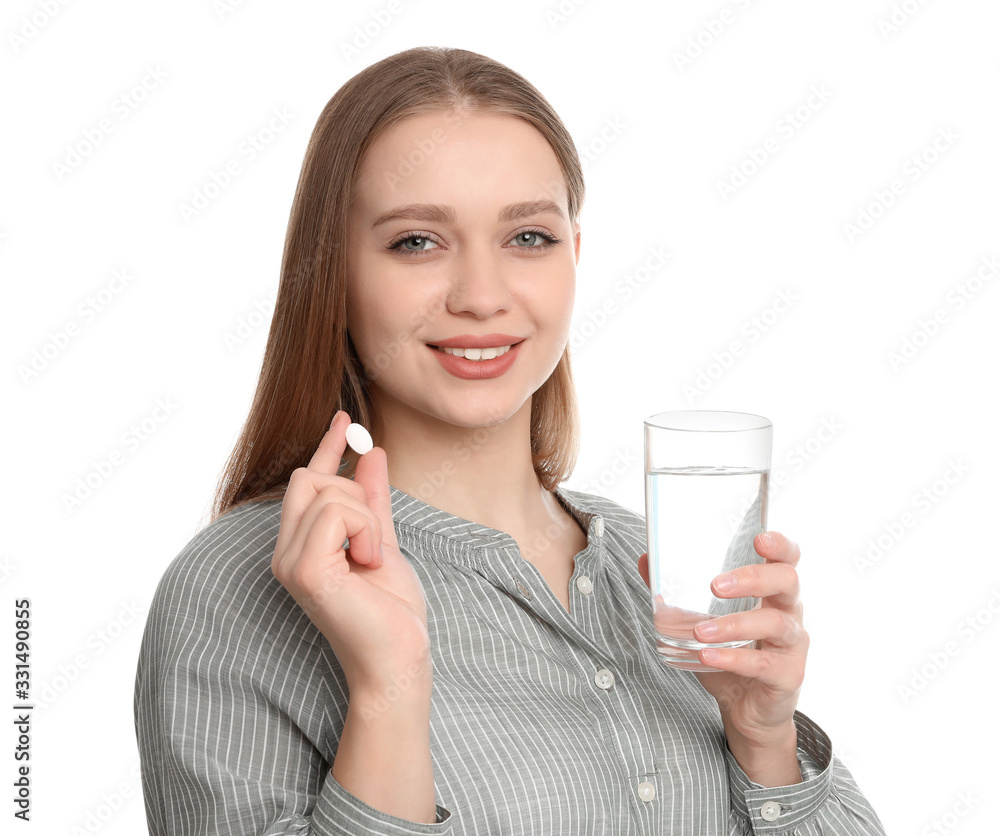 Young woman with glass of water and vitamin pill on white background Young woman with glass of water and vitamin pill on white background