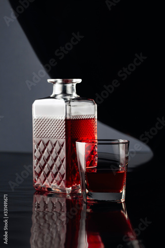 Decanter and glass of whiskey on a black  background.