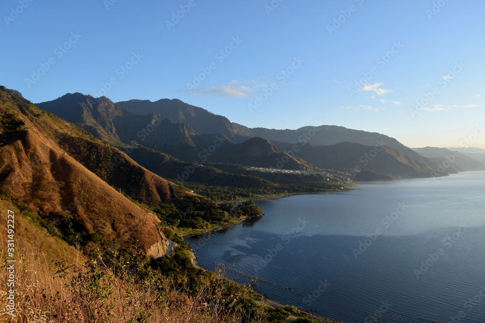 Hilly landscape with shores of lake in a sunny day