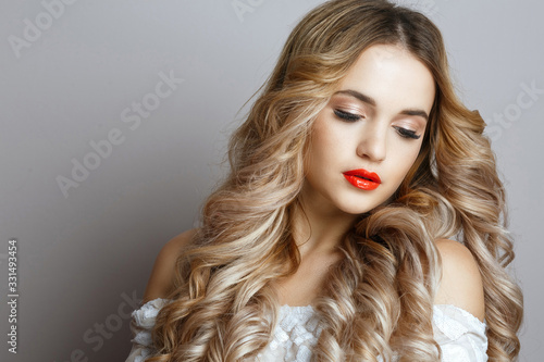 Beauty portrait of luxury girl with long wavy hair