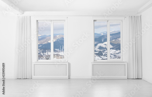 Fototapeta Naklejka Na Ścianę i Meble -  Beautiful view of snowy mountains through windows