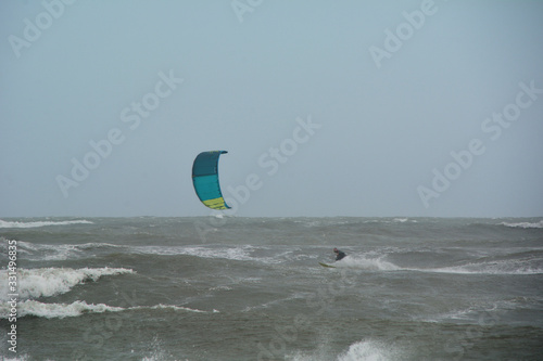 A person doing ski surfing on a stormy day