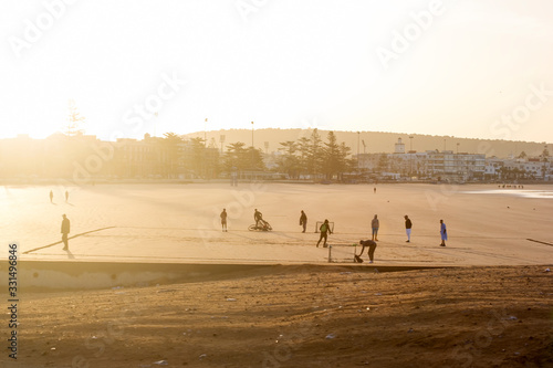 Morning sunrise view at the beach, people playing, Essaouira, Morocco 
