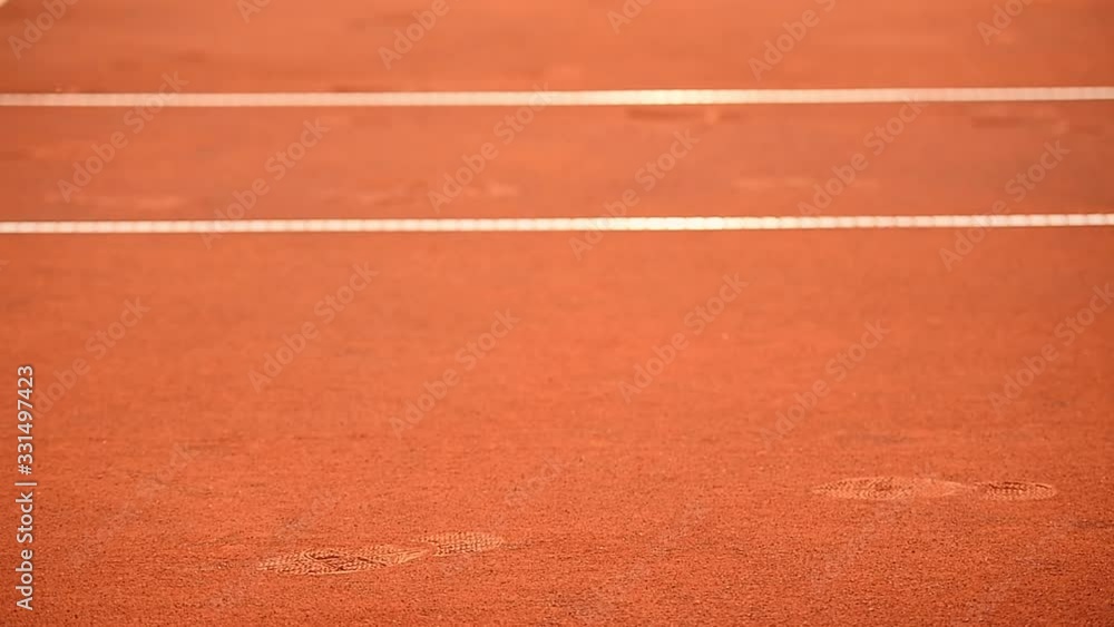 Detail with sport shoe footprint on a tennis clay court during a match Detail with sport shoe footprint on a tennis clay court during a match