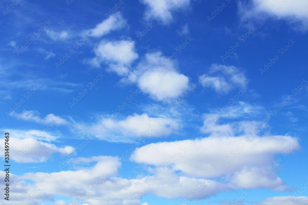 Beautiful blue sky and white cumulus and cirrus clouds. Background. Scenery. Beautiful blue sky and white cumulus and cirrus clouds. Background. Scenery.
