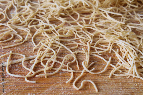 Dried thin homemade soup noodles. Close-up. Background. Texture.