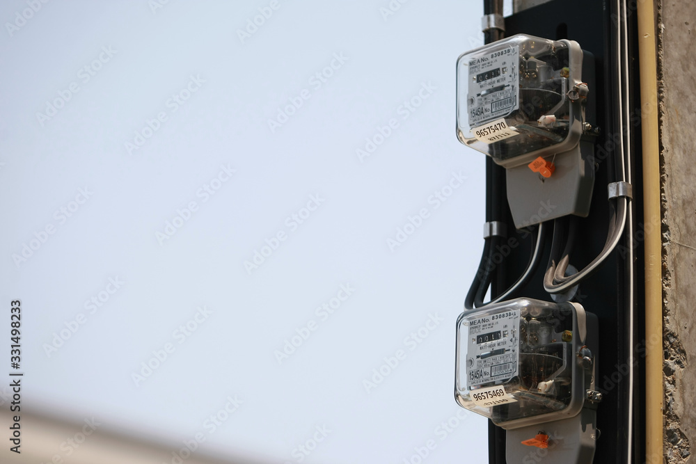 Electricity meter on the electricity post in the village , on 2020 March 14 , Bangkok Thailand Electricity meter on the electricity post in the village , on 2020 March 14 , Bangkok Thailand