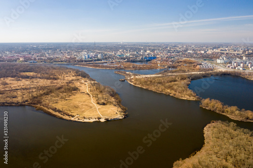 Aerial shot of the city of Gomel and the Sozh River in early spring. 17 microdistrict and Volotova. Sozh River and lakes. View of Gomel from a height. Beautiful landscape. Aerial view of the city.