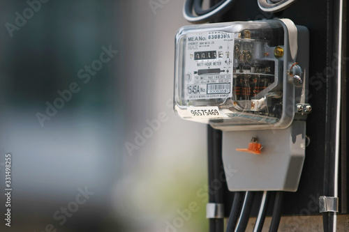 Electricity meter on the electricity post in the village , on 2020 March 14 , Bangkok Thailand photo