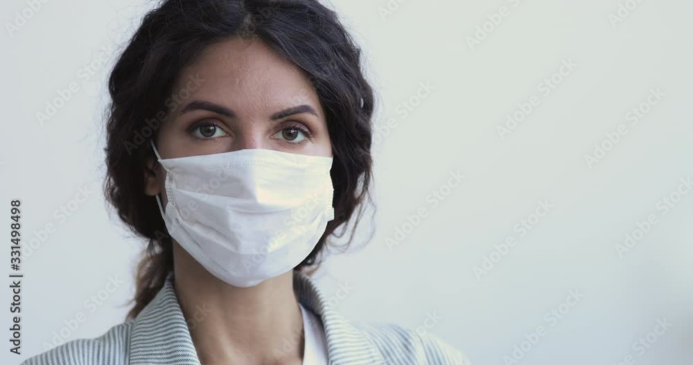 Coronavirus spreading prevention concept. Young woman having covid 19 mers cov virus infection looking at camera wearing medical face mask protects from bacteria, flu, air pollution. Close up portrait Coronavirus spreading prevention concept. Young woman having covid 19 mers cov virus infection looking at camera wearing medical face mask protects from bacteria, flu, air pollution. Close up portrait