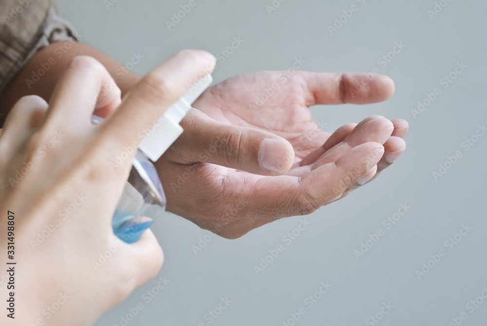 Naklejka premium washing hands with spraying alcohol, for coronavirus and preventions. sanitizer concept