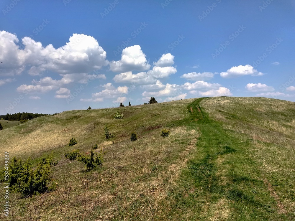 Obraz premium Spring road to the clouds