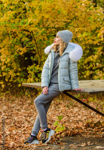 Clothes for rest. Girl relaxing in nature wearing knitwear suit and jacket. Model knitwear clothes leaves background. Warm knitwear. Feel practicality and comfort. Woman enjoy autumn season in park