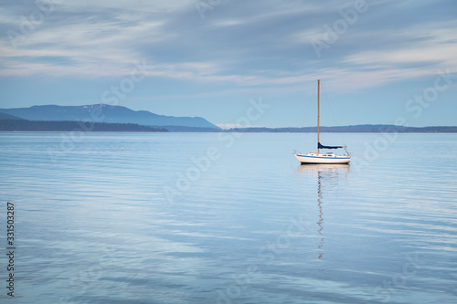 Sailboat anchored in Bellingham Bay on a calm morning. Bellingham.  Washington. Bellingham. Washington. United States photo