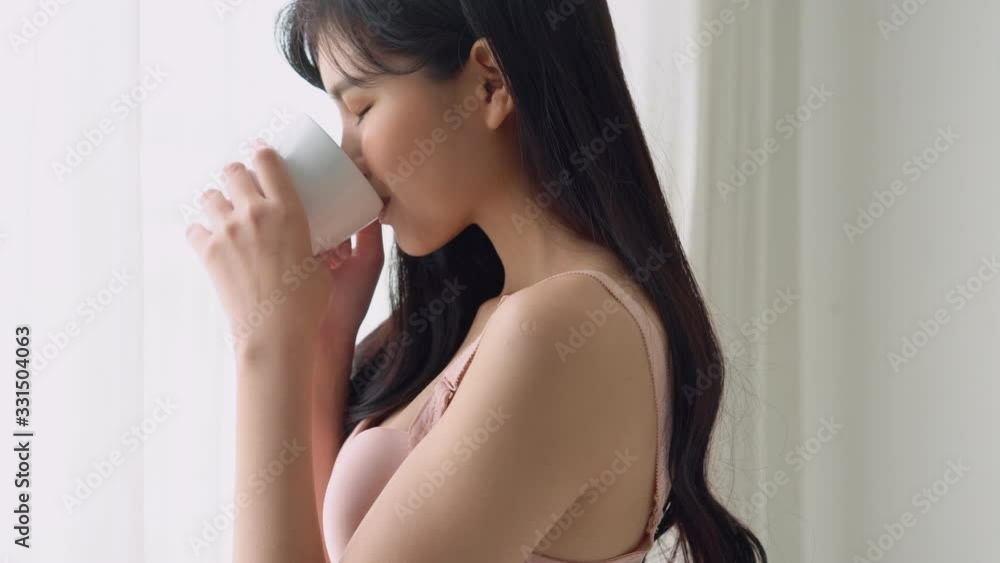 Beautiful young asian woman happy and confident drinking cup of coffee with fresh and looking windows at home, lifestyle asia girl relax in the room at home for wellness and health concept. Beautiful young asian woman happy and confident drinking cup of coffee with fresh and looking windows at home, lifestyle asia girl relax in the room at home for wellness and health concept.