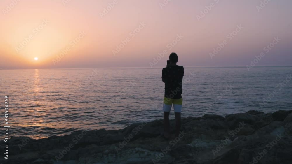 An amazing sunset and a man taking a picture, in slow motion. An amazing sunset and a man taking a picture, in slow motion.