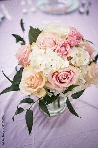 Wedding bouquet on reception table © Brett