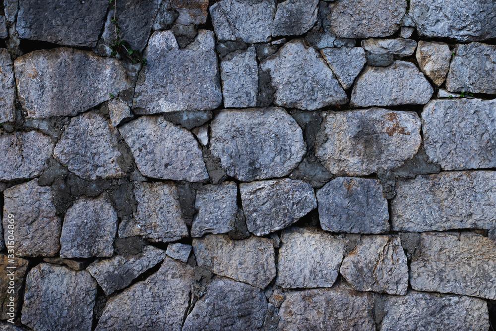 Texture of stone wall made of grey stones Texture of stone wall made of grey stones