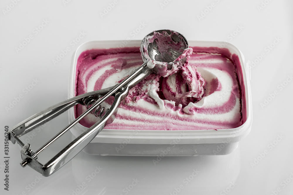Vanilla and mulberry ice cream with metal scoop on white background Vanilla and mulberry ice cream with metal scoop on white background