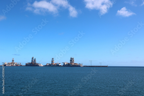 cargo ship going to a harbour in a calm sea with clear sky in summer