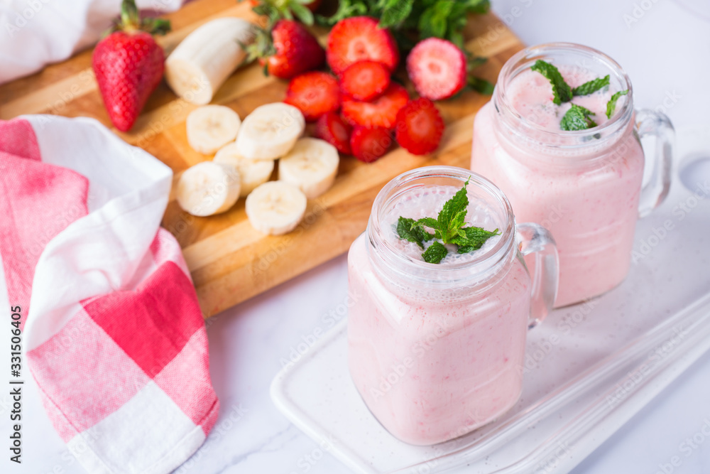 Pink smoothie with banana and strawberry for healthy, vegan diet Pink smoothie with banana and strawberry for healthy, vegan diet