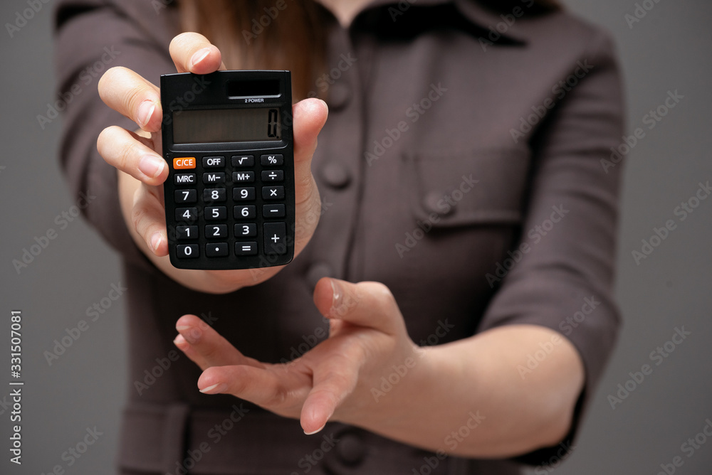 Calculator with zero on the display in business lady hands close up. Calculator with zero on the display in business lady hands close up.