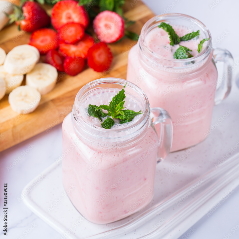 Pink smoothie with banana and strawberry for healthy, vegan diet Pink smoothie with banana and strawberry for healthy, vegan diet