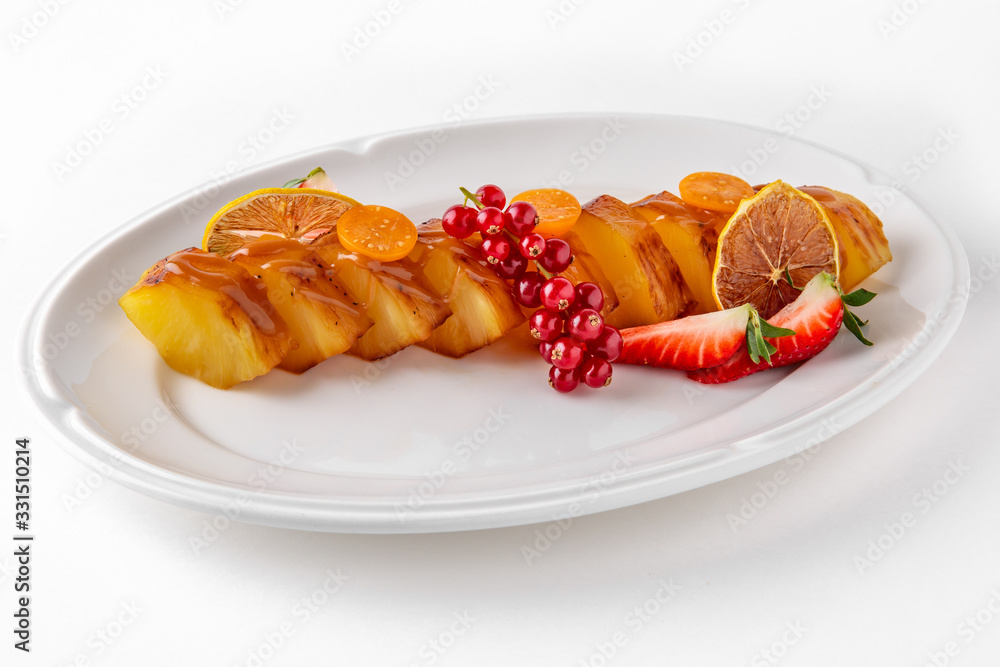 Dessert fried caramelized pineapple in own juice and berries. Banquet festive dishes. Gourmet restaurant menu. White background. Dessert fried caramelized pineapple in own juice and berries. Banquet festive dishes. Gourmet restaurant menu. White background.