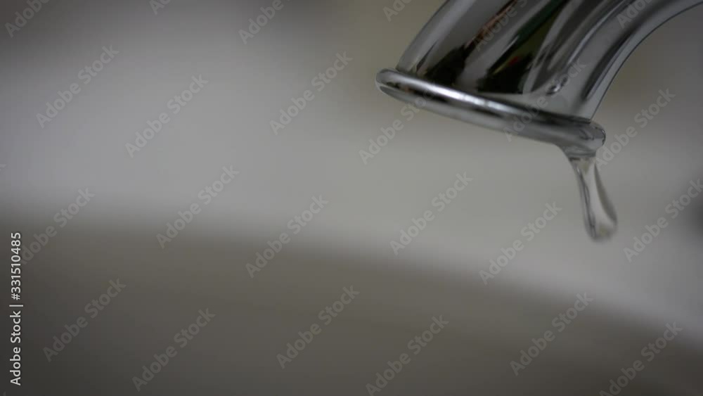Water faucet with single drop falling out. Water faucet with single drop falling out.