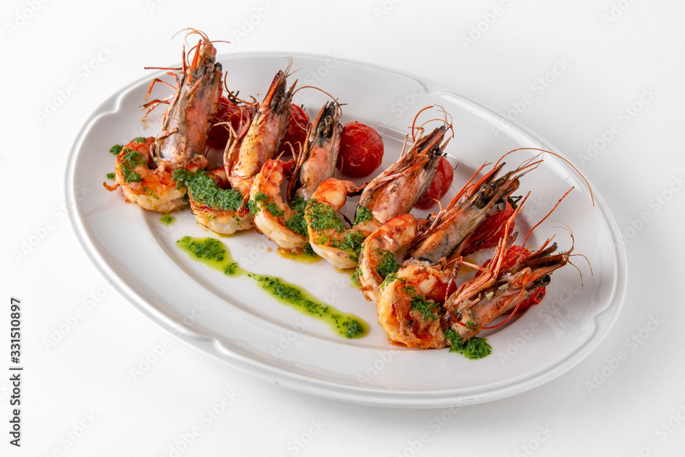 Luxurious seafood salad with grilled king prawns and baked cherry tomatoes. Banquet festive dishes. Gourmet restaurant menu. White background. Luxurious seafood salad with grilled king prawns and baked cherry tomatoes. Banquet festive dishes. Gourmet restaurant menu. White background.
