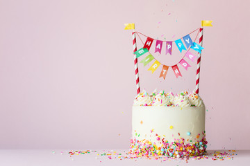 Birthday cake with colorful happy birthday banner