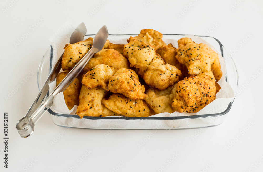 Don't throw stale,Ramadan bread into the trash but deep fry it with egg.Fried bread pieces in the glass plate with steel tongs. Don't throw stale,Ramadan bread into the trash but deep fry it with egg.Fried bread pieces in the glass plate with steel tongs.