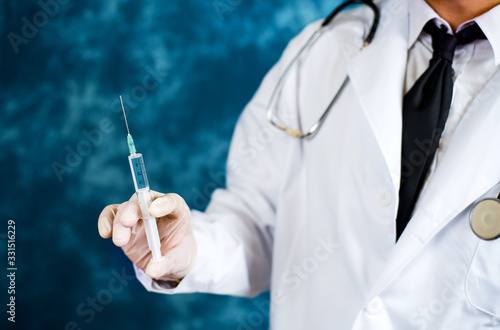Doctor holding a syringe close up