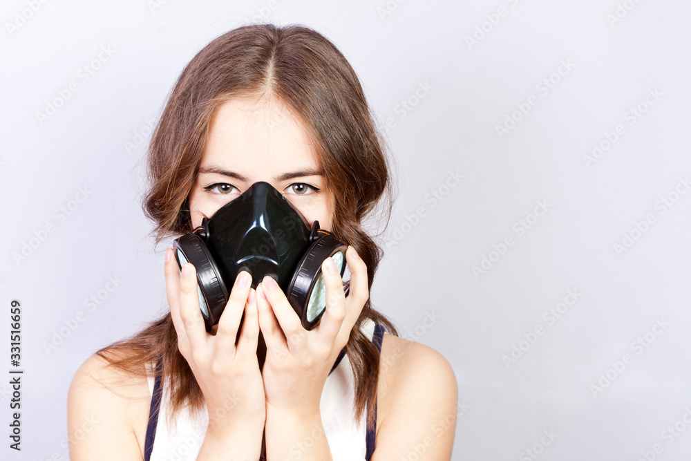 Teen girl in a respirator, respiratory protection. Coronavirus(COVID-19) and healthcare concept.