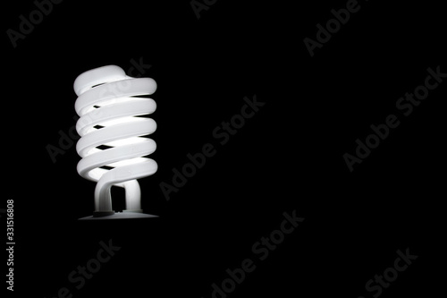 energy saving bulb on black background