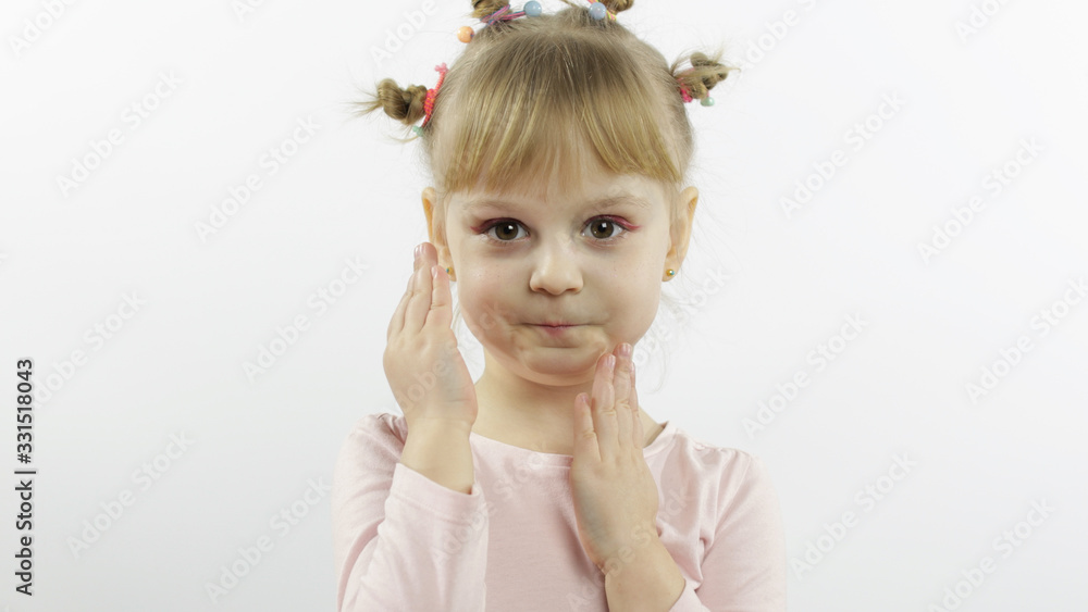 Positive girl emotionally make faces and smile in pink blouse. White background Positive girl emotionally make faces and smile in pink blouse. White background