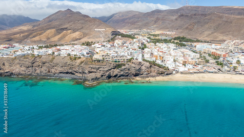 Fototapeta Naklejka Na Ścianę i Meble -  Morro Jable Canary Island, Fuerteventura Spain, Aerial view on coast of atlantic ocean and beach, Drone shot of sea 