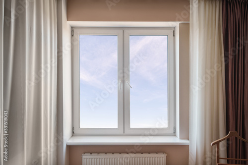 White window in the living room with sky