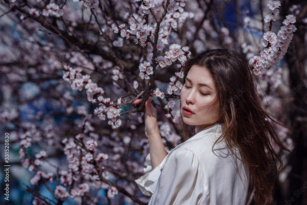 young asian woman in a flowering garden young asian woman in a flowering garden
