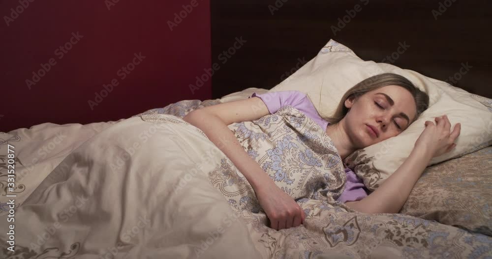 Calm young woman sleeping in bed Calm young woman sleeping in bed
