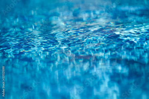 refreshing blue swimming pool water on a tropical summer holiday. Full Frame Macro close up photo with selective focus and copy space. © remotevfx
