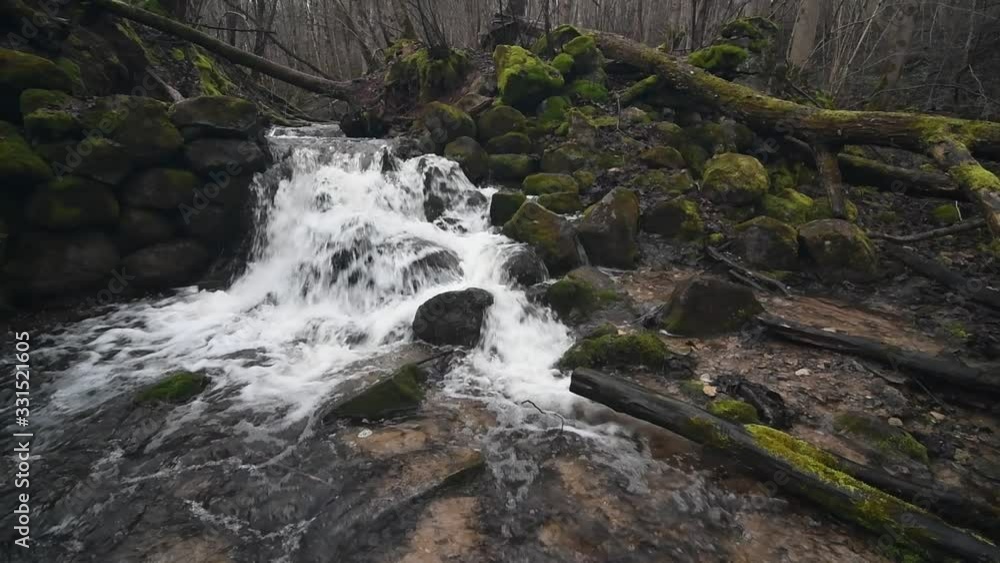 Waterfall flowing over rock at spring. Beautiful forest. Waterfall flowing over rock at spring. Beautiful forest.